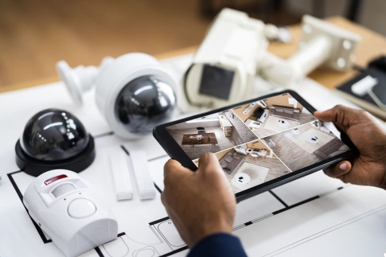 A collection of home security camera systems displayed on a table, showcasing various models and features for home protection.